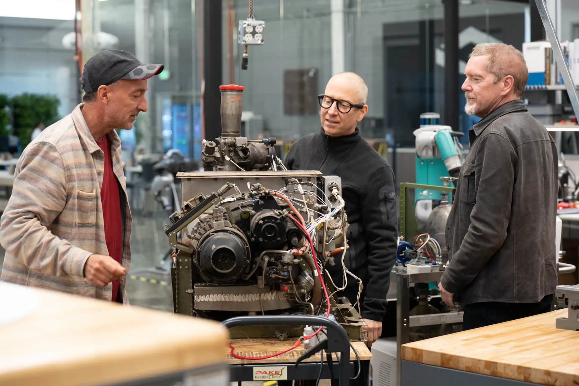 Engineers look over an APU engine.